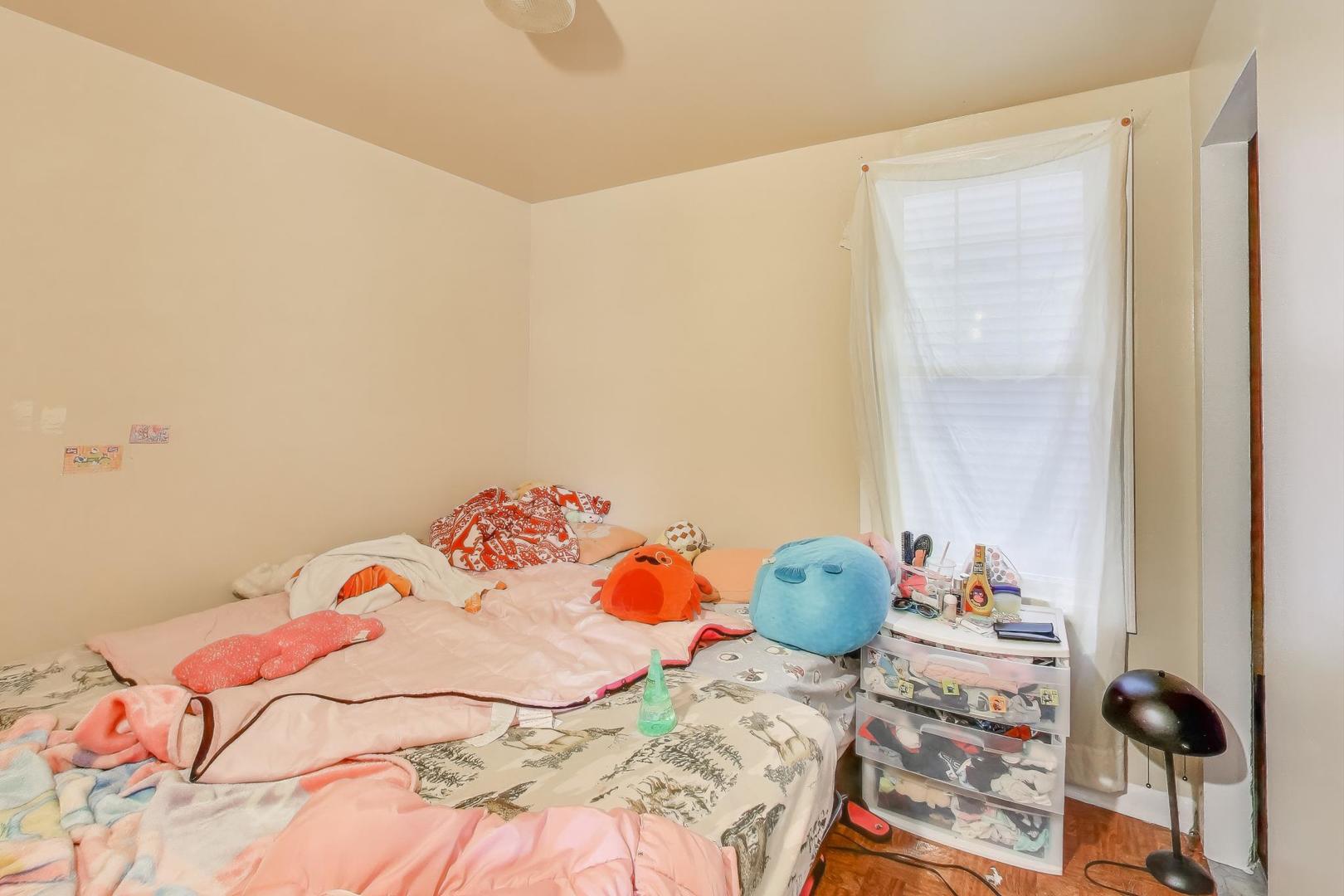 4322 North Monticello Avenue Chicago, IL 60618 - Photo 7 of 37 a bedroom with a bed and a window