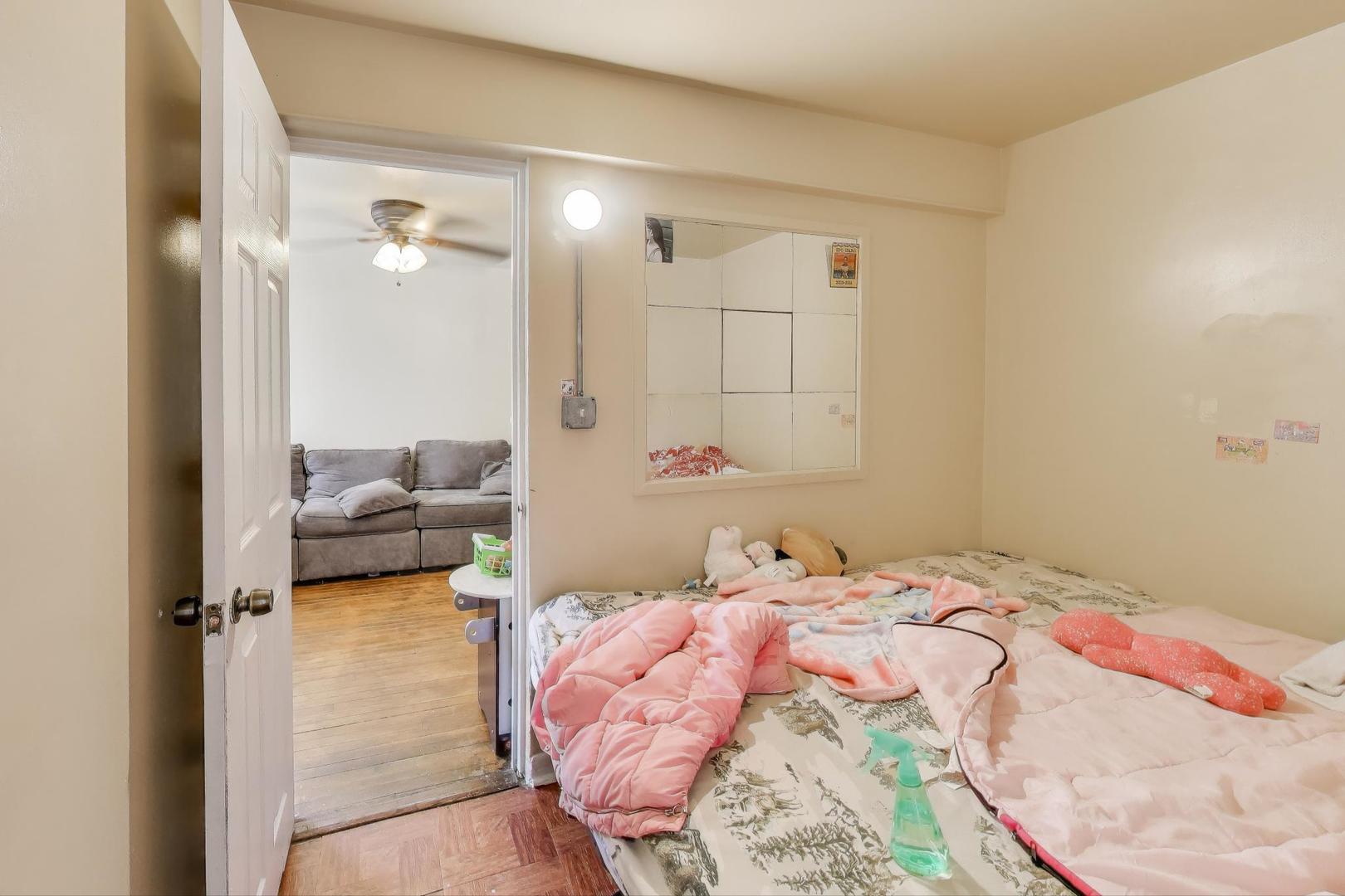 4322 North Monticello Avenue Chicago, IL 60618 - Photo 8 of 37 a bedroom with a bed and a mirror