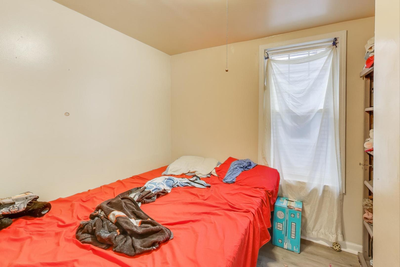 4322 North Monticello Avenue Chicago, IL 60618 - Photo 9 of 37 a bed sitting in a bedroom next to a window