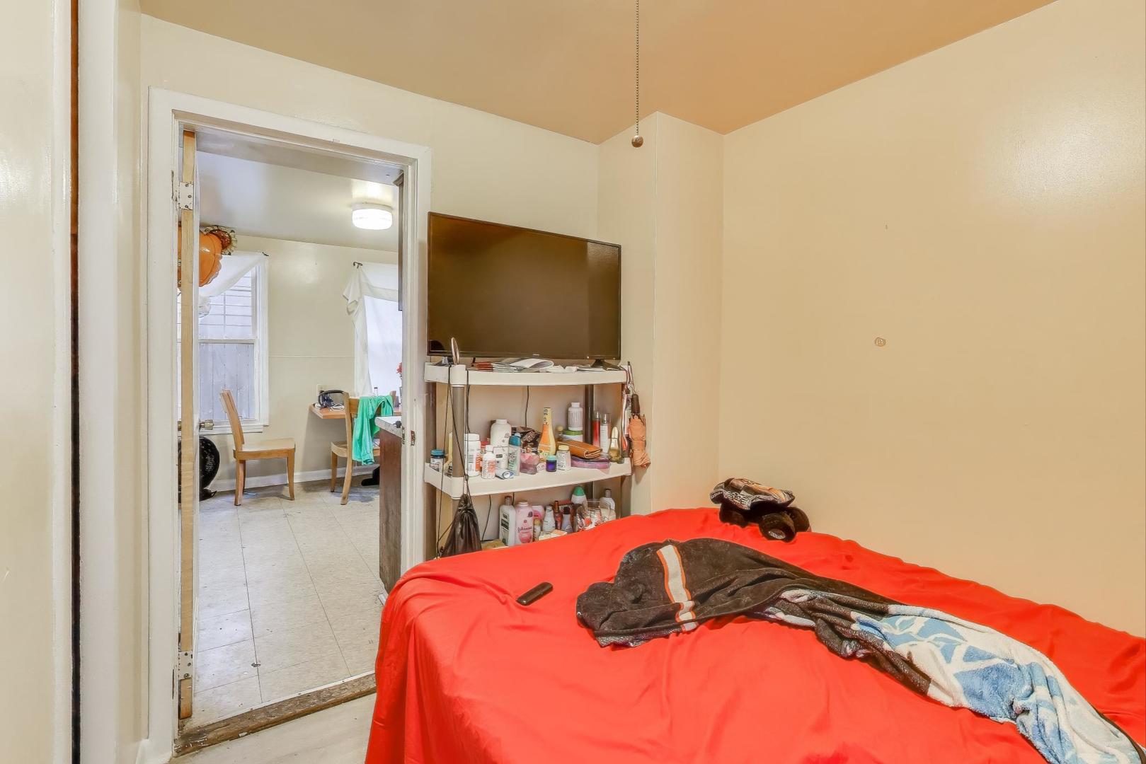 4322 North Monticello Avenue Chicago, IL 60618 - Photo 10 of 37 a bedroom with a bed and a flat screen tv