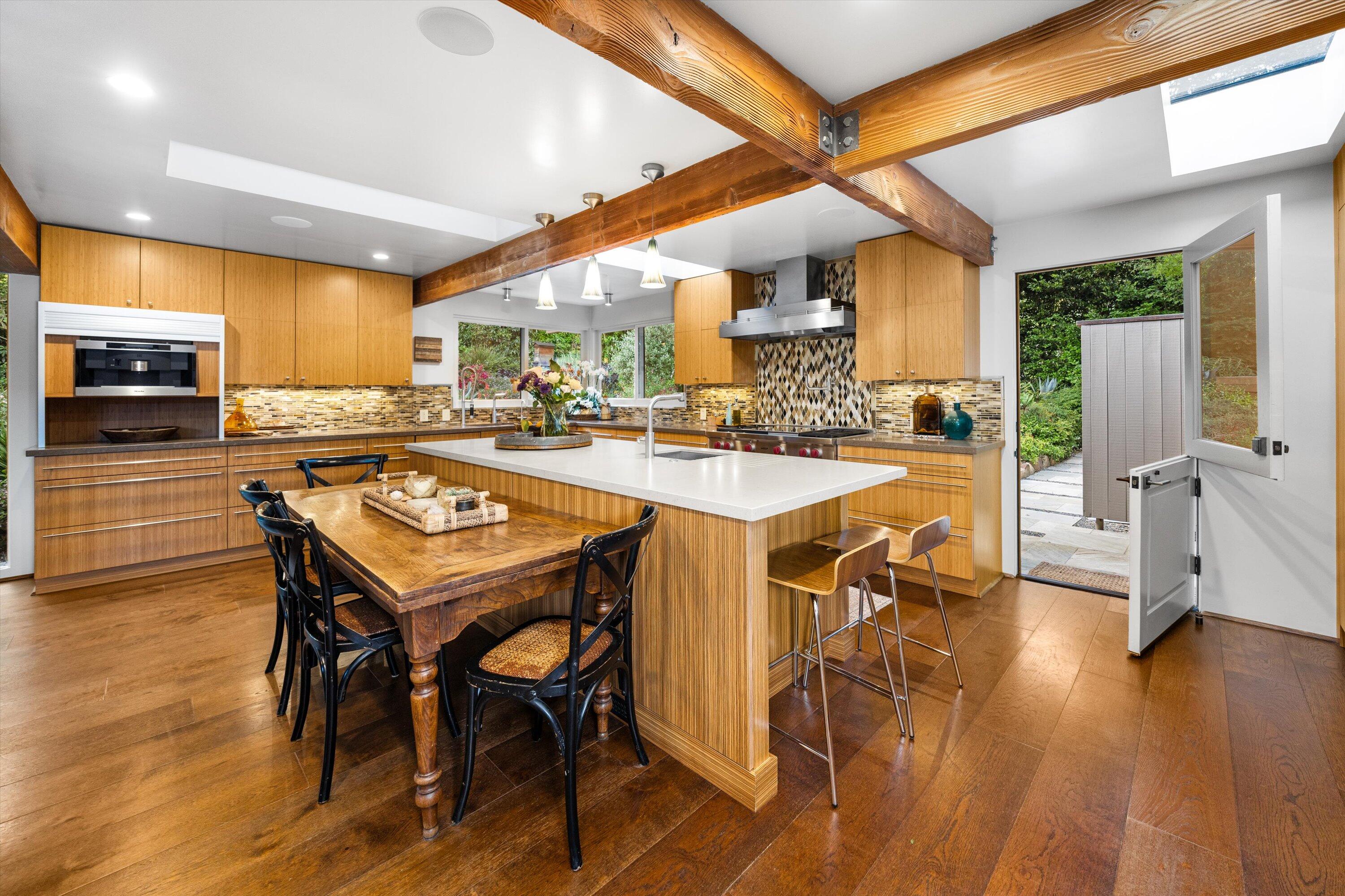 655 Oak Springs Lane Santa Barbara, CA 93108 - Photo 13 of 39 a kitchen with a table chairs stove and cabinets