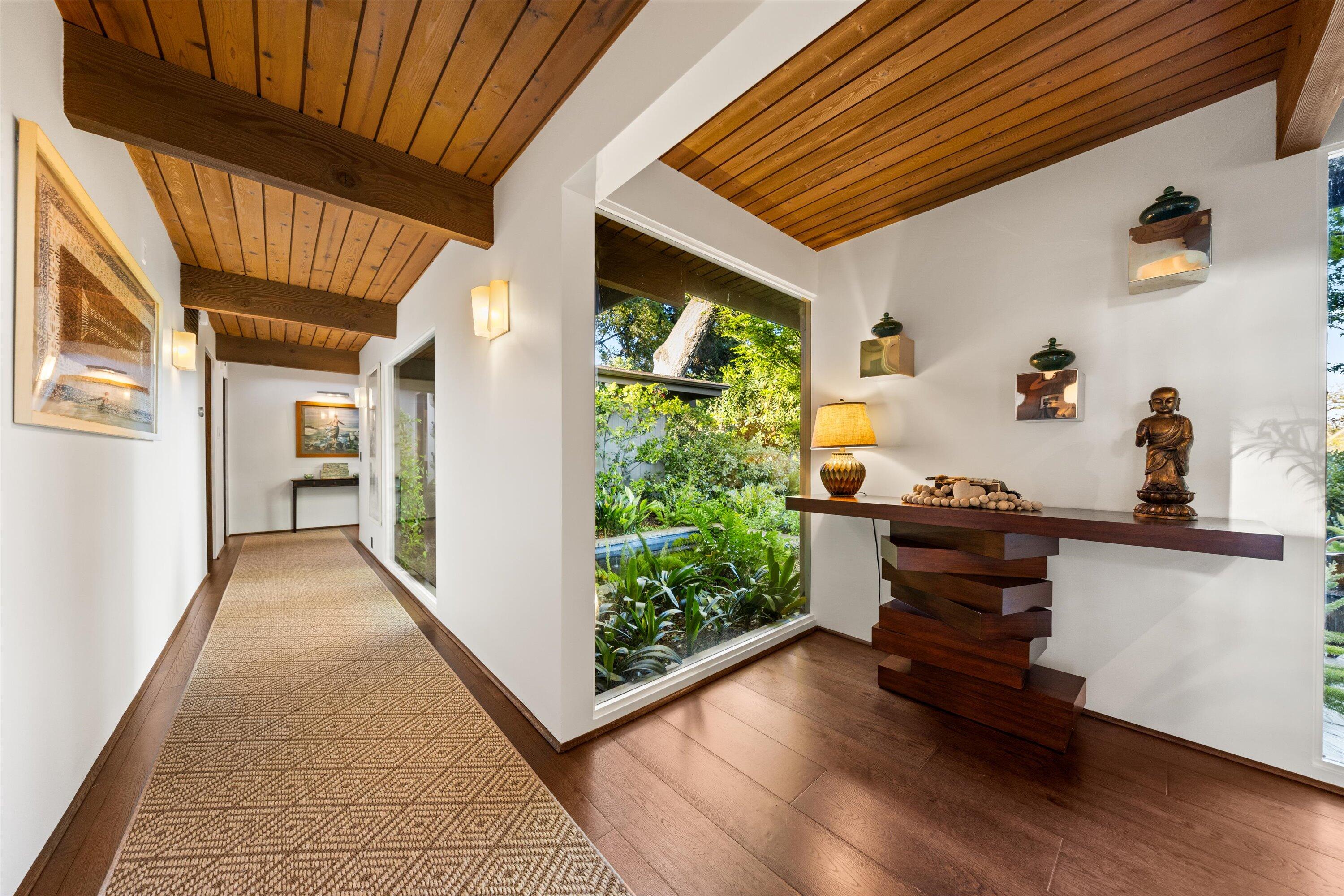655 Oak Springs Lane Santa Barbara, CA 93108 - Photo 25 of 39 a view of a hallway with wooden floor and a dining space