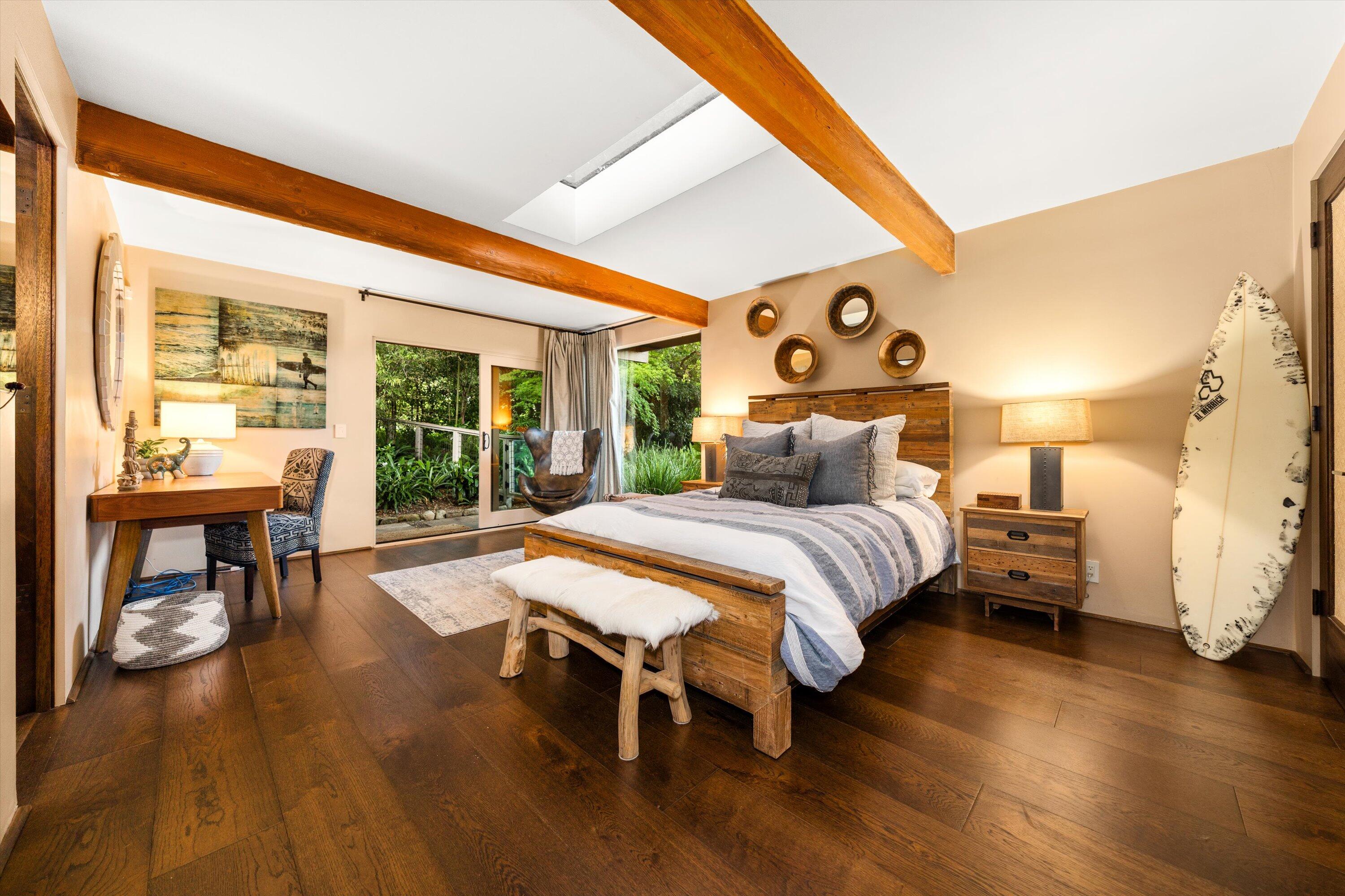 655 Oak Springs Lane Santa Barbara, CA 93108 - Photo 30 of 39 a bedroom with a bed and wooden floor