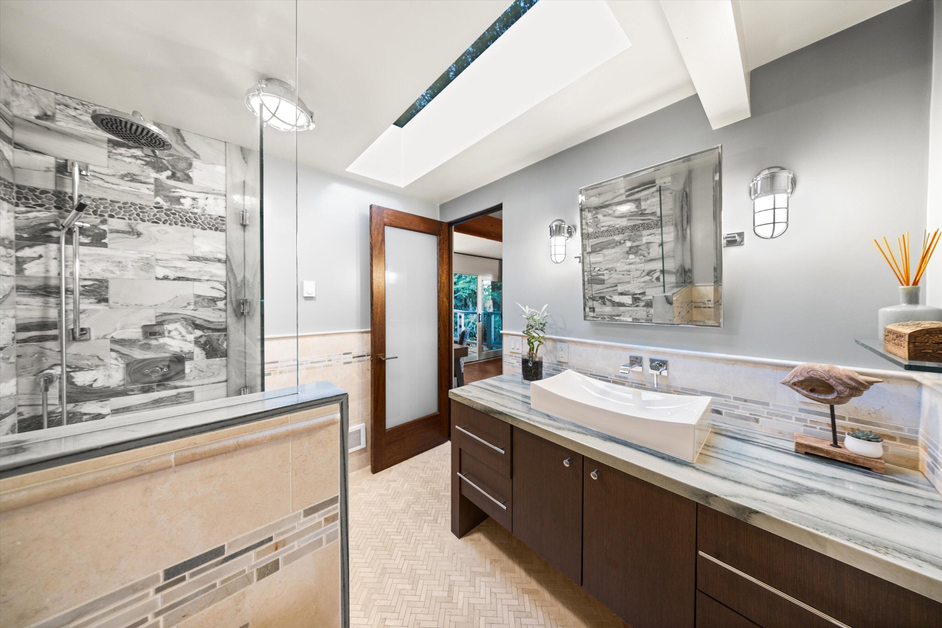 655 Oak Springs Lane Santa Barbara, CA 93108 - Photo 31 of 39 a spacious bathroom with a granite countertop sink mirror and a shower