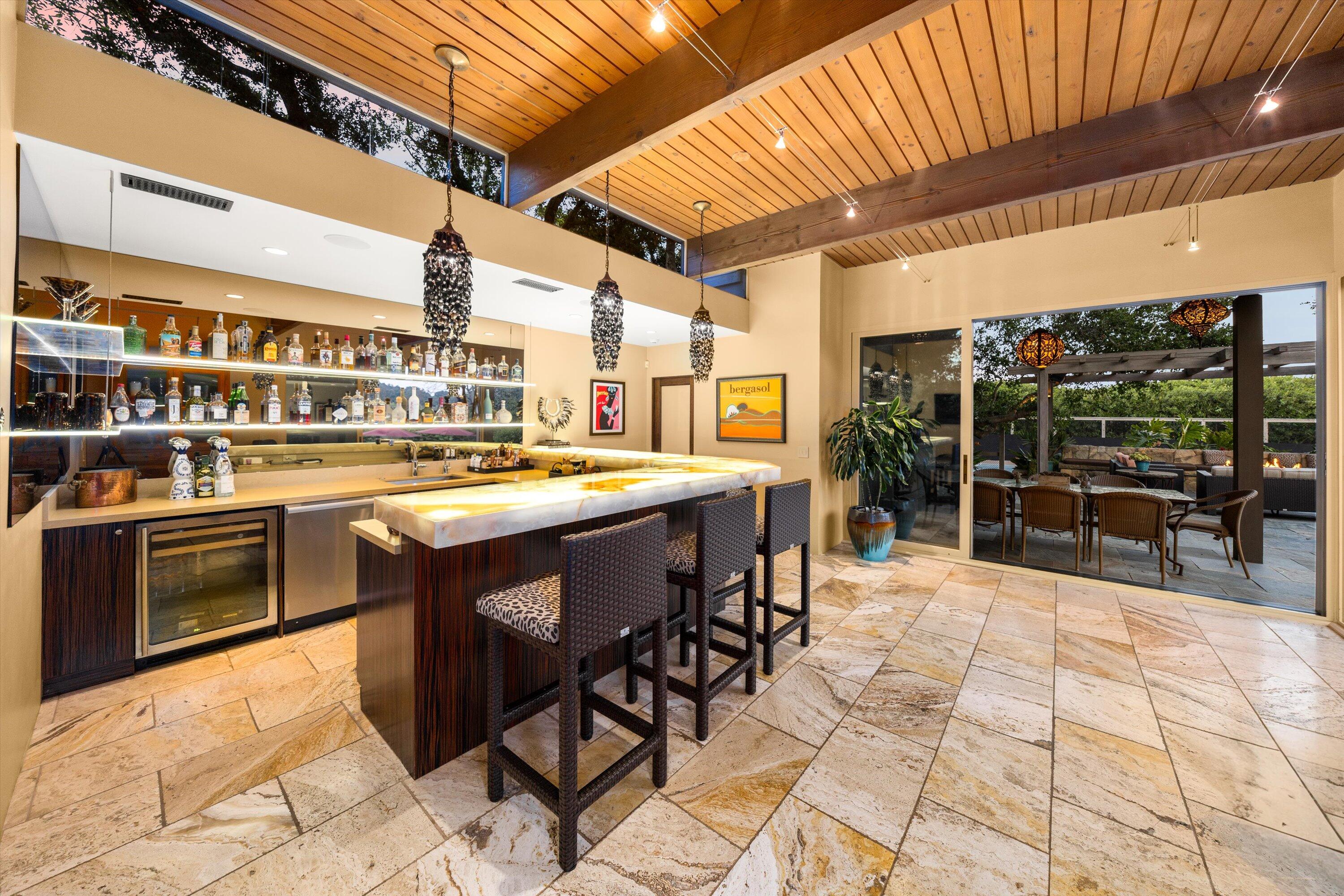 655 Oak Springs Lane Santa Barbara, CA 93108 - Photo 32 of 39 a view of a patio with dining table and chairs with wooden floor
