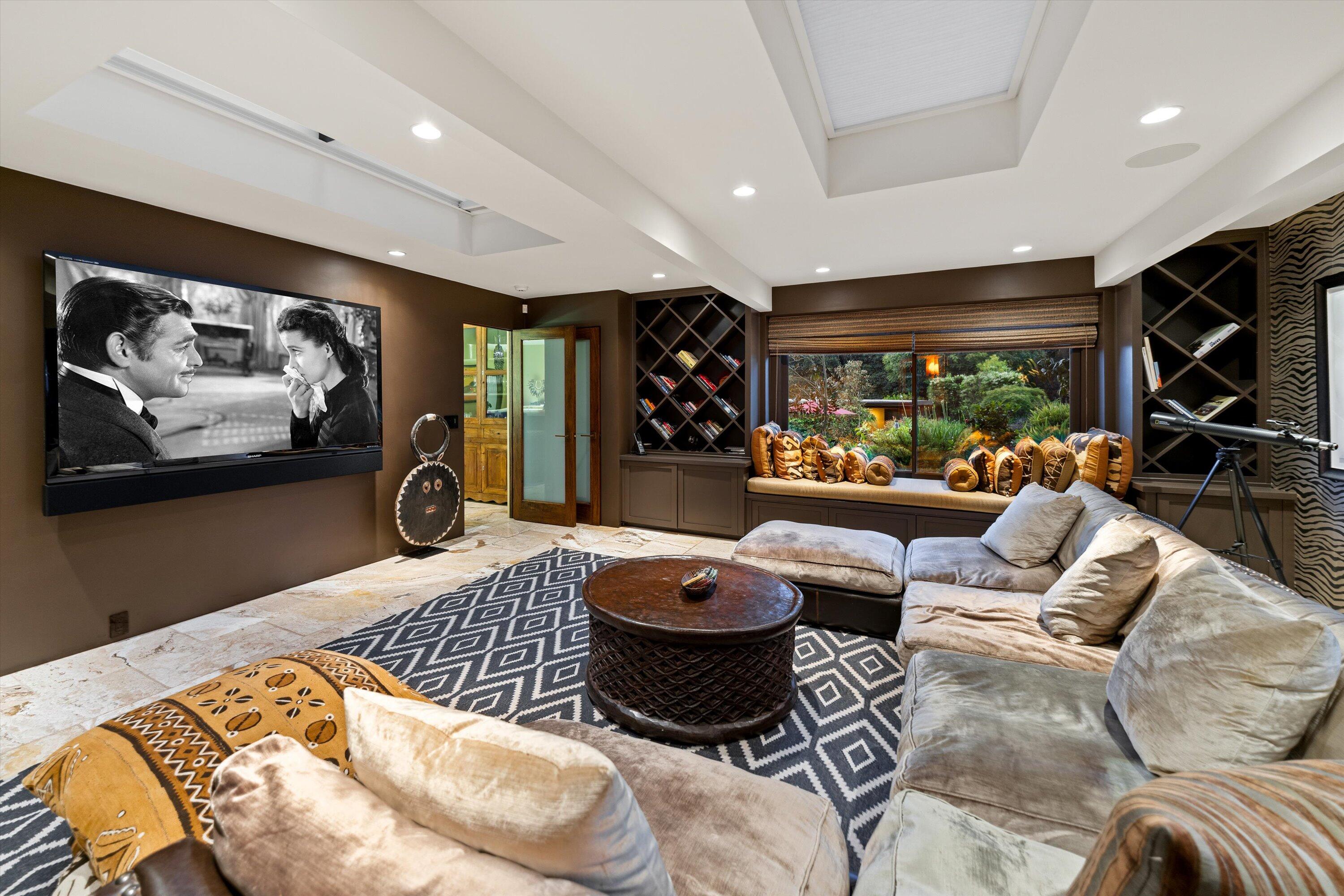 655 Oak Springs Lane Santa Barbara, CA 93108 - Photo 34 of 39 a living room with furniture a rug and a flat screen tv