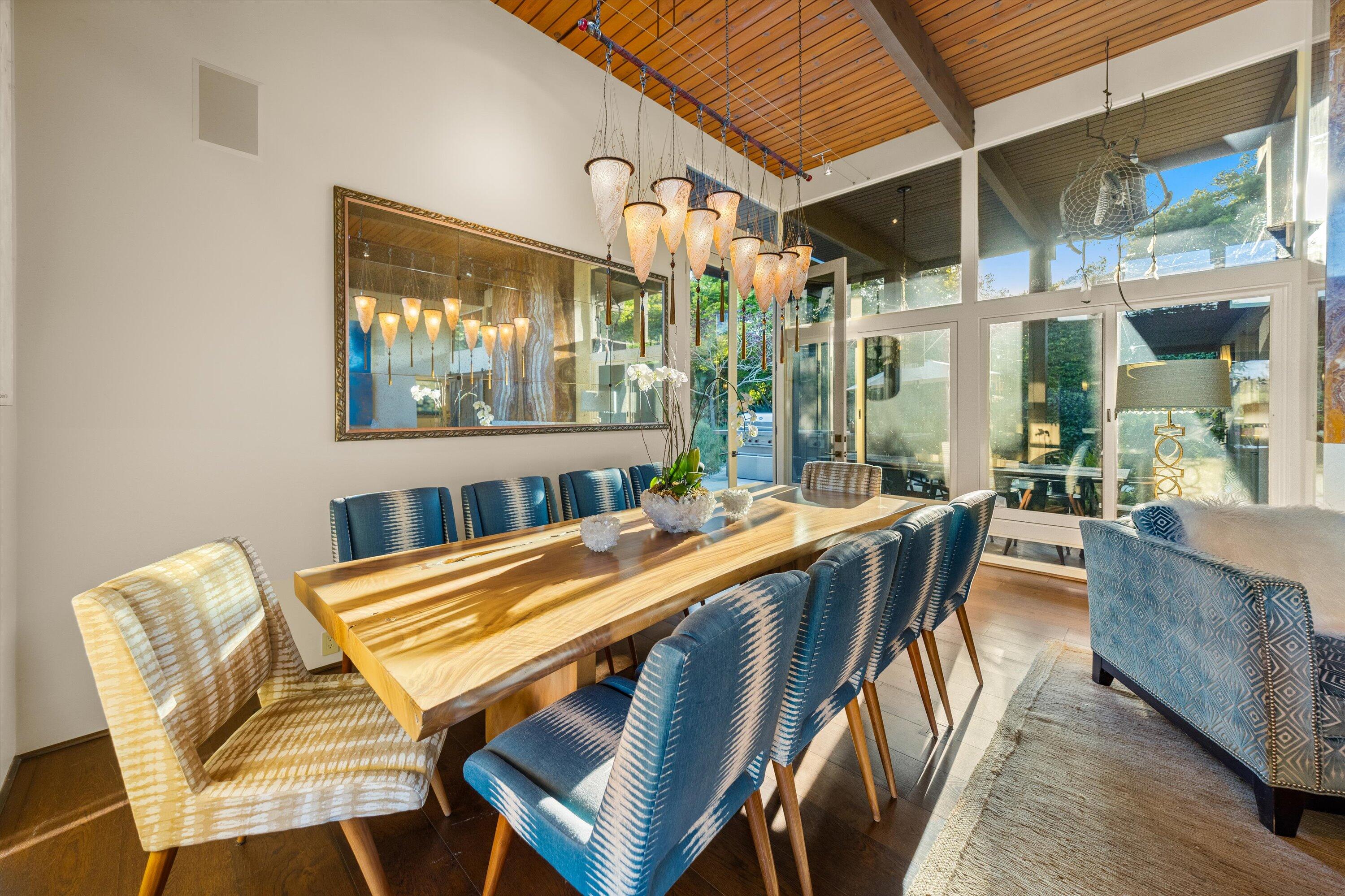655 Oak Springs Lane Santa Barbara, CA 93108 - Photo 9 of 39 a view of a dining room with furniture a chandelier and wooden floor