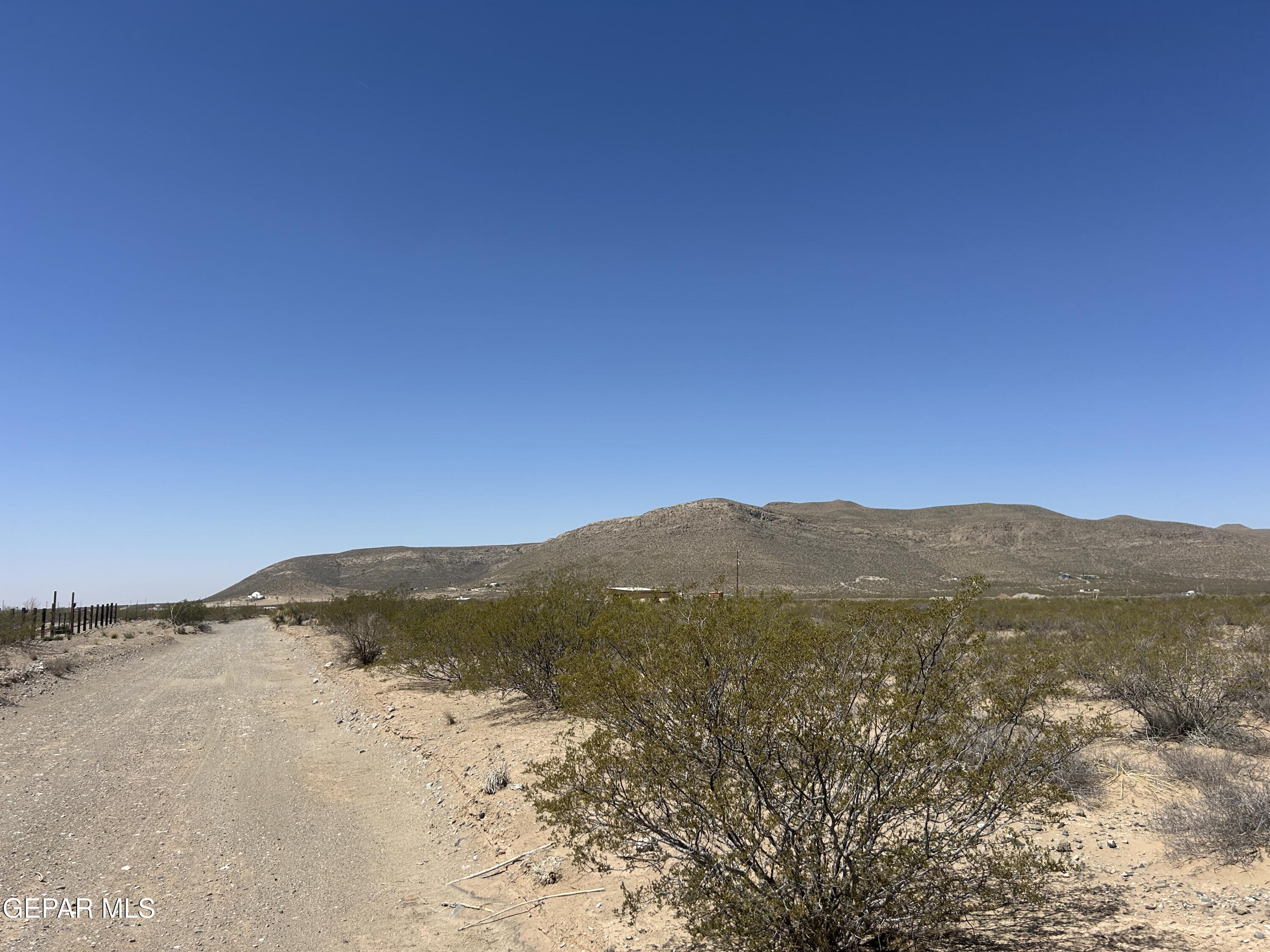 17099 Timmer Road El Paso, TX 79938 - Photo 7 of 19 a view of a mountain range in a cloudy sky