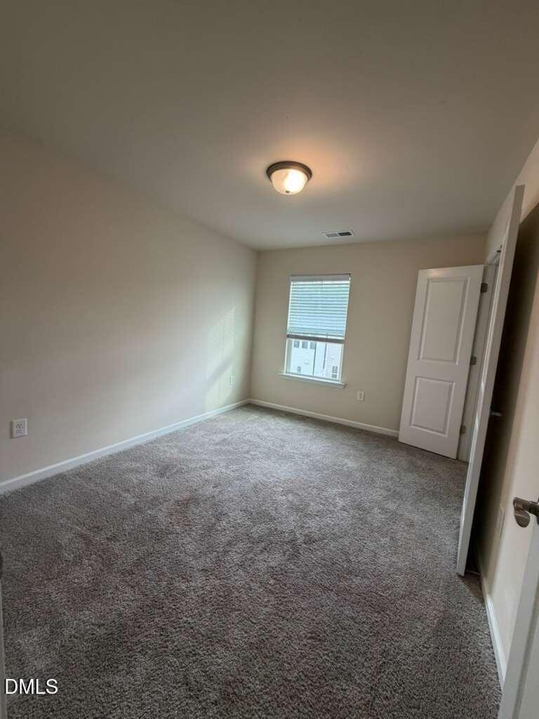 336 Abbots Ml Drive Raleigh, NC 27603 - Photo 11 of 25 an empty room with a window and a fireplace