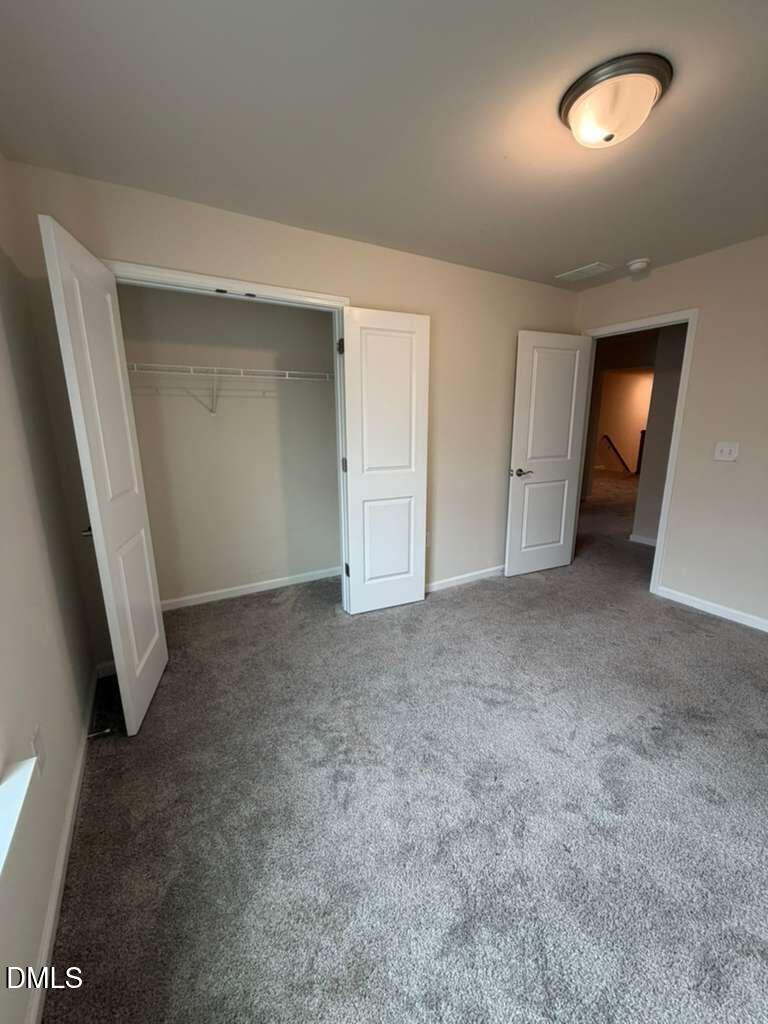 336 Abbots Ml Drive Raleigh, NC 27603 - Photo 13 of 25 an empty room with closet and mirror