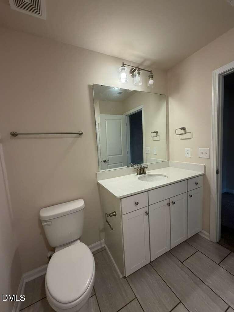 336 Abbots Ml Drive Raleigh, NC 27603 - Photo 14 of 25 a bathroom with a toilet sink and mirror