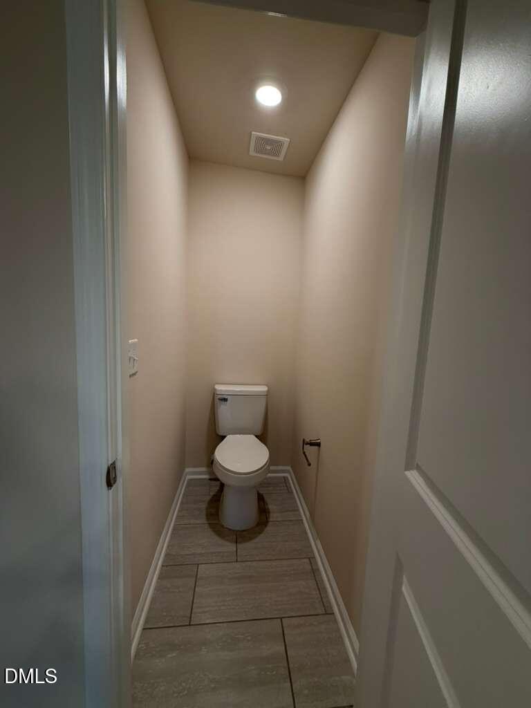 336 Abbots Ml Drive Raleigh, NC 27603 - Photo 19 of 25 a bathroom with a toilet and a mirror