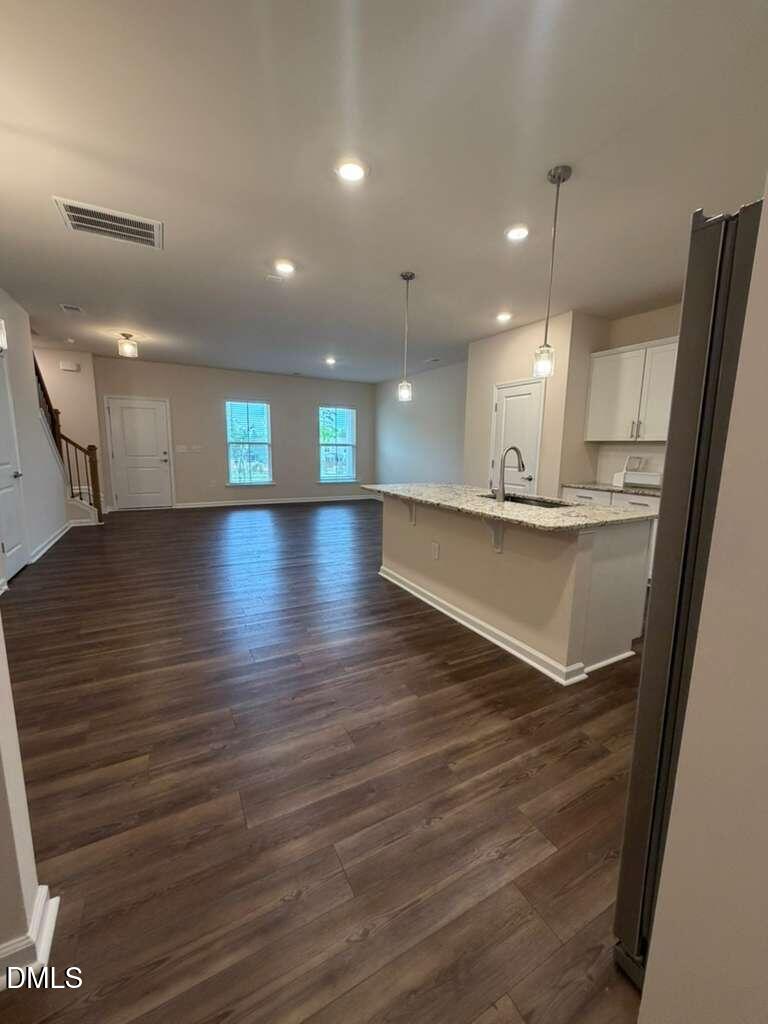 336 Abbots Ml Drive Raleigh, NC 27603 - Photo 2 of 25 a view of a room with kitchen island wooden floors and kitchen view