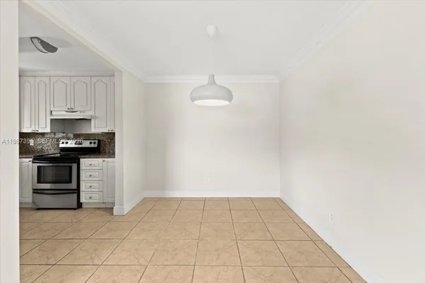 a view of kitchen with white cabinets