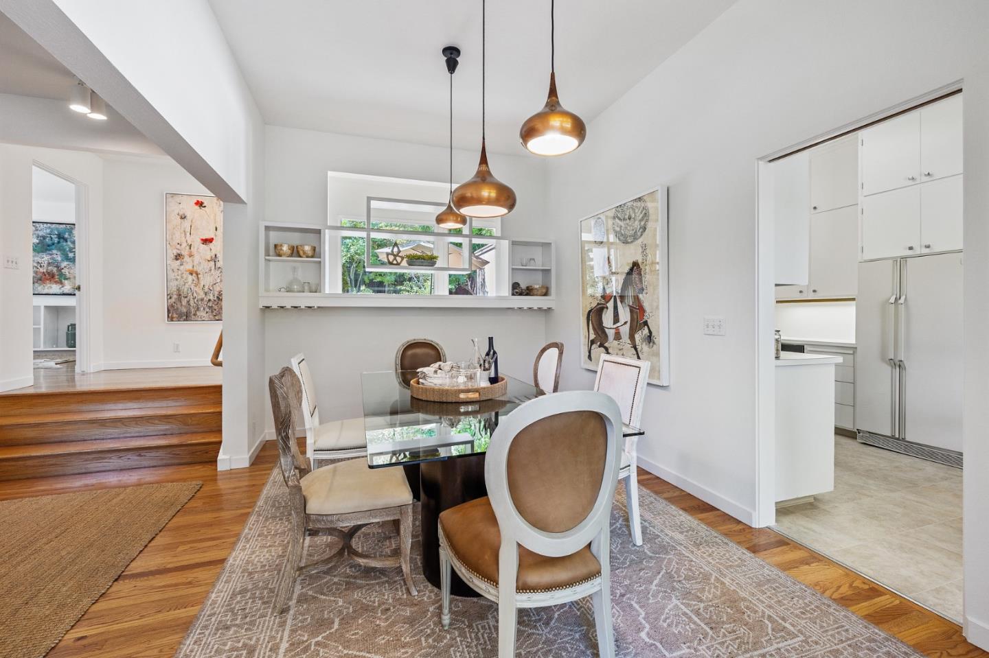 729 Tolman Drive Stanford, CA 94305 - Photo 11 of 48 a kitchen with granite countertop a dining table chairs and a refrigerator