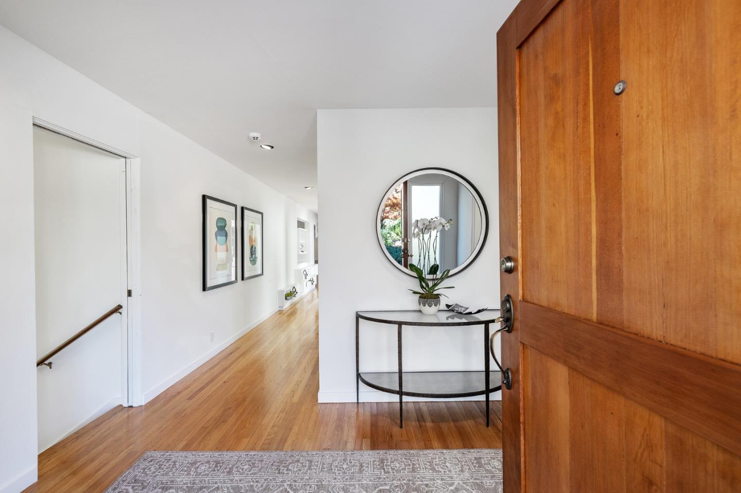 729 Tolman Drive Stanford, CA 94305 - Photo 3 of 48 a living room with a wooden floor and a mirror