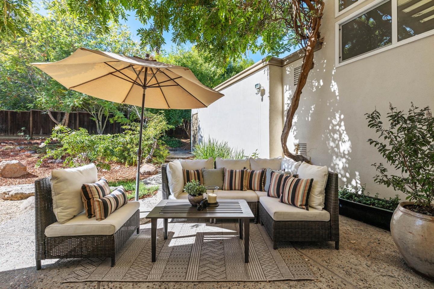 729 Tolman Drive Stanford, CA 94305 - Photo 22 of 48 a view of a patio with couches table and chairs under an umbrella