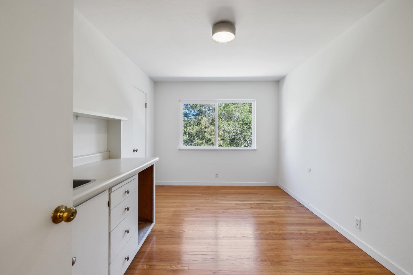 729 Tolman Drive Stanford, CA 94305 - Photo 32 of 48 an empty room with wooden floor and windows