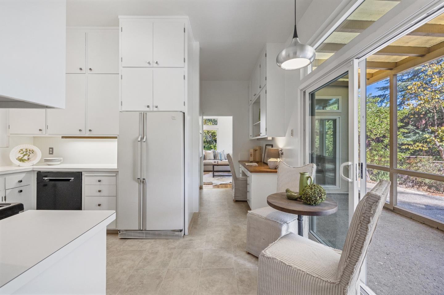 729 Tolman Drive Stanford, CA 94305 - Photo 9 of 48 a kitchen with a refrigerator a stove a dining table and chairs