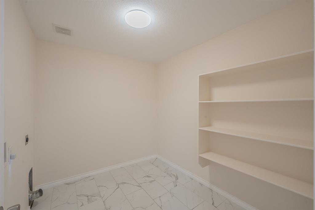 12109 Arbor Lake Road Rhome, TX 76078 - Photo 17 of 33 Spacious laundry room with extra pantry storage.