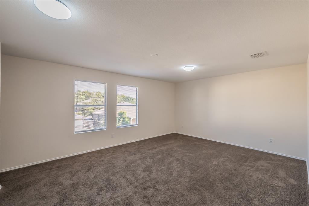 12109 Arbor Lake Road Rhome, TX 76078 - Photo 19 of 33 Unfurnished room featuring dark carpet and baseboards