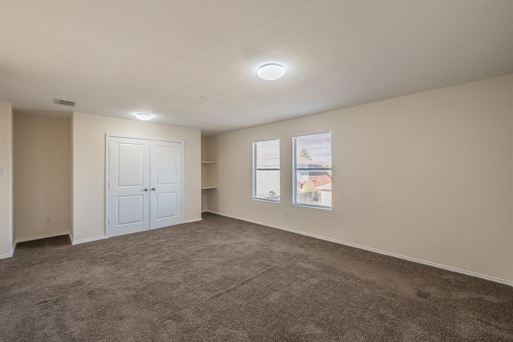 12109 Arbor Lake Road Rhome, TX 76078 - Photo 20 of 33 Unfurnished bedroom with dark carpet and a closet