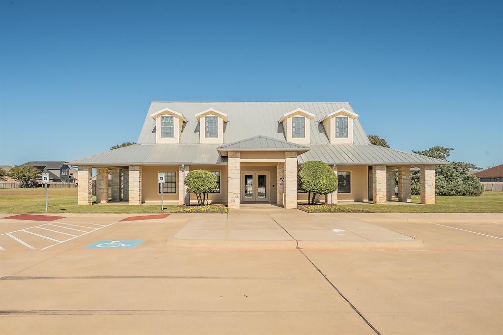 12109 Arbor Lake Road Rhome, TX 76078 - Photo 29 of 34 View of building exterior featuring uncovered parking
