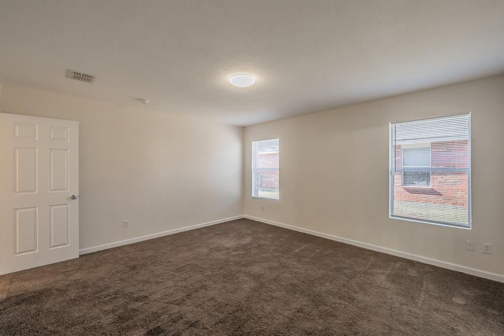 12109 Arbor Lake Road Rhome, TX 76078 - Photo 6 of 33 Spare room with dark colored carpet and baseboards