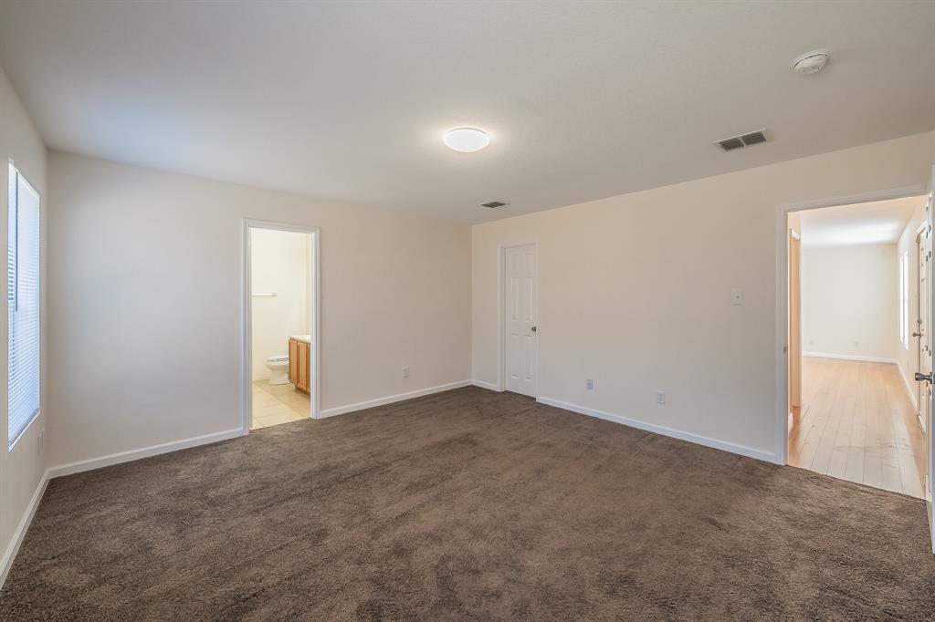 12109 Arbor Lake Road Rhome, TX 76078 - Photo 7 of 33 Unfurnished bedroom featuring light carpet and ensuite bathroom