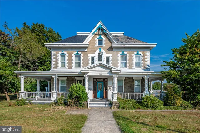 a front view of a house with garden and porch