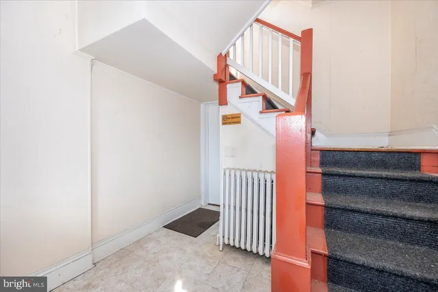 a view of staircase with lots of frames and wooden floor