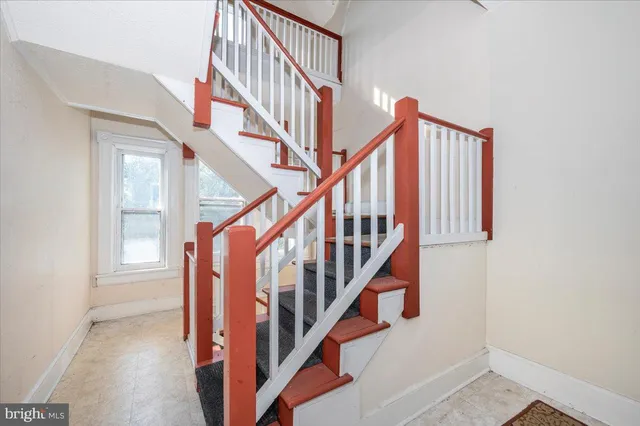 a view of staircase with wooden floor and rug