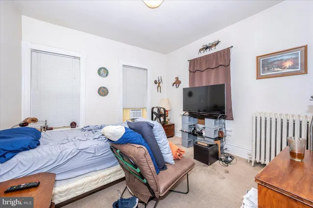 a view of staircase with railing and white walls