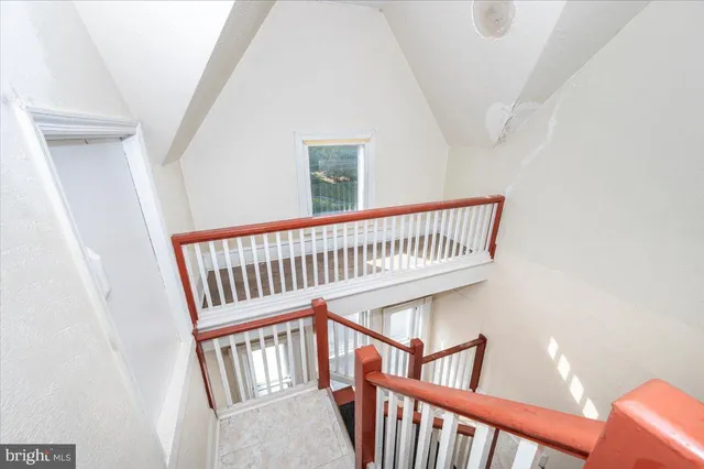 a utility room with fridge and window