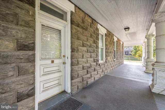 a white kitchen with a sink a stove and a window