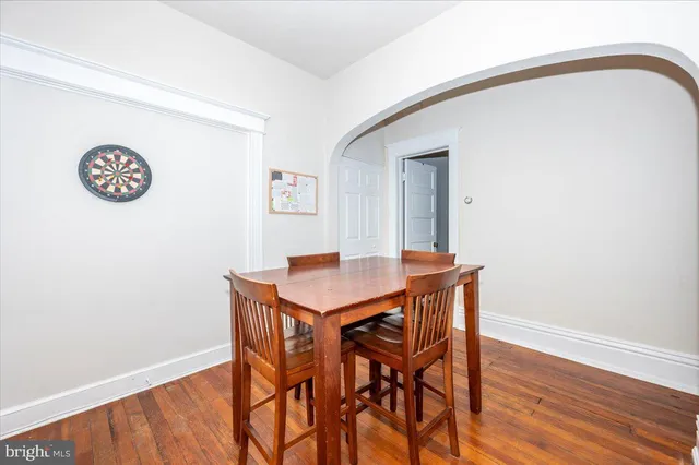 a view of a room with a table and chairs