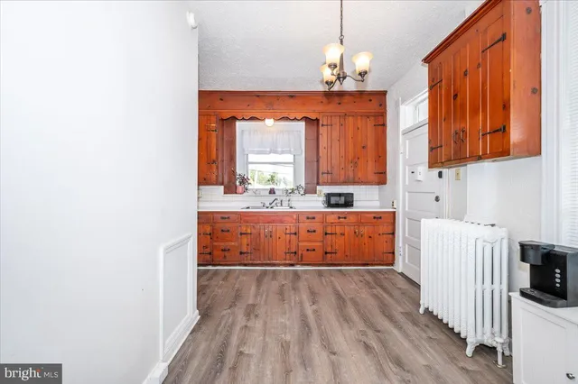 a room with a bed mirror and a window