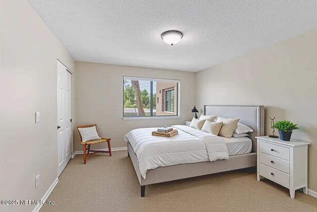 a bedroom with a bed and window