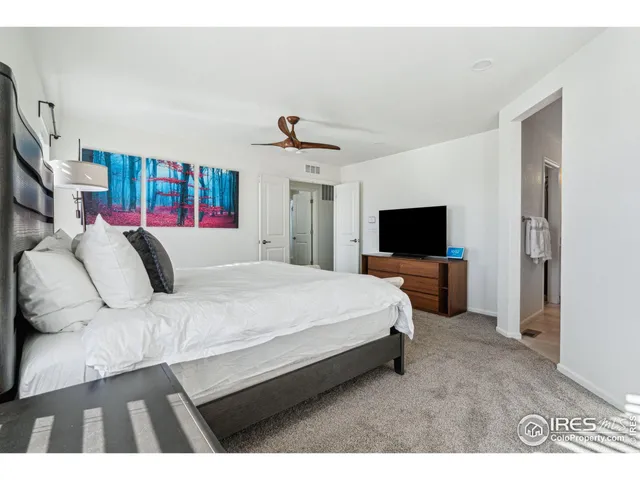 a bed room with a bed a television and a couch