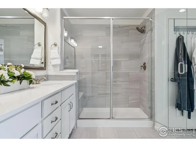 a bathroom with a shower and a sink