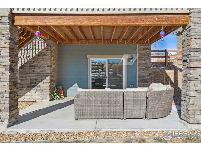 a living room with furniture a flat screen tv and a floor to ceiling window