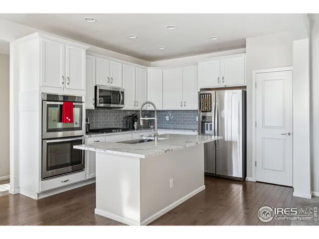 a kitchen with stainless steel appliances a stove refrigerator sink and microwave