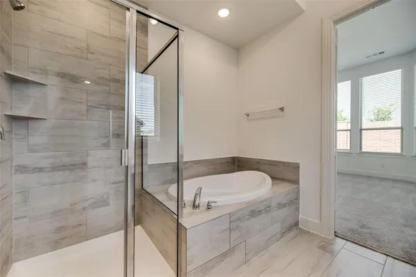a bathroom with a tub and shower