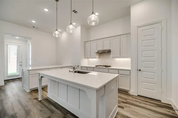 a kitchen that has a lot of cabinets in it
