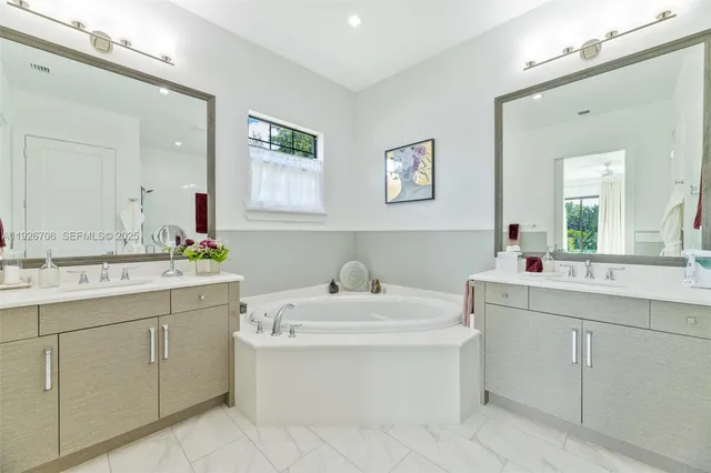 a bathroom with a sink mirror and a toilet