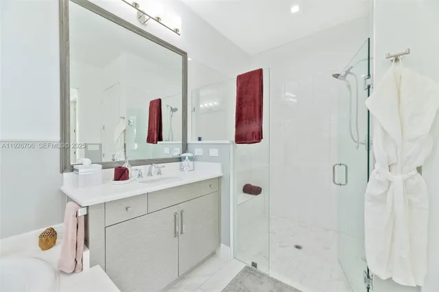 a bathroom with a sink vanity and mirror