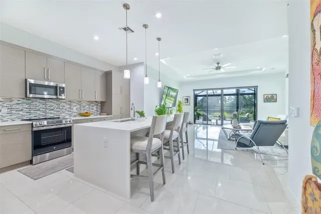 a kitchen with a table chairs stove and cabinets