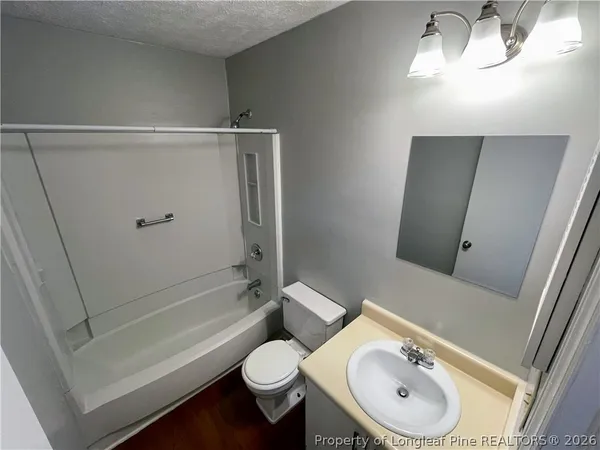 a bathroom with a toilet a sink and bathtub