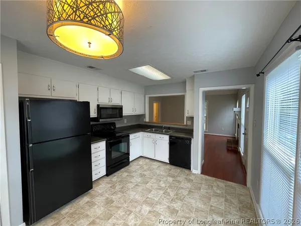 a kitchen with a refrigerator and a sink