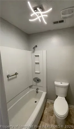a bathroom with a toilet and a bathtub